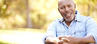 Older man with dental implants in Allentown smiling outside