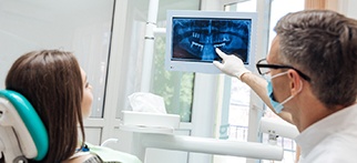 Implant dentist in Allentown showing patient an X-ray