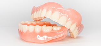 Full set of dentures on white background
