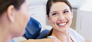women smiling at dentist