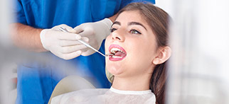 dentist checking women's smile
