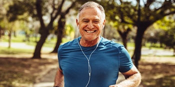 Senior man jogging and smiling