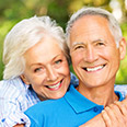 elderly couple smiling in blue