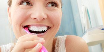 woman brushing teeth