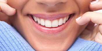 women in blue sweater smiling