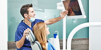 dentist showing patient photo