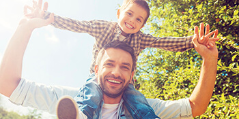 dad with son on shoulders