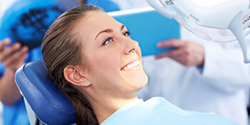 women smiling in exam chair