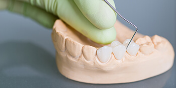 dentist working on dental bridge