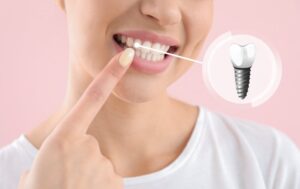 Woman smiling confidently while pointing at her dental implant 
