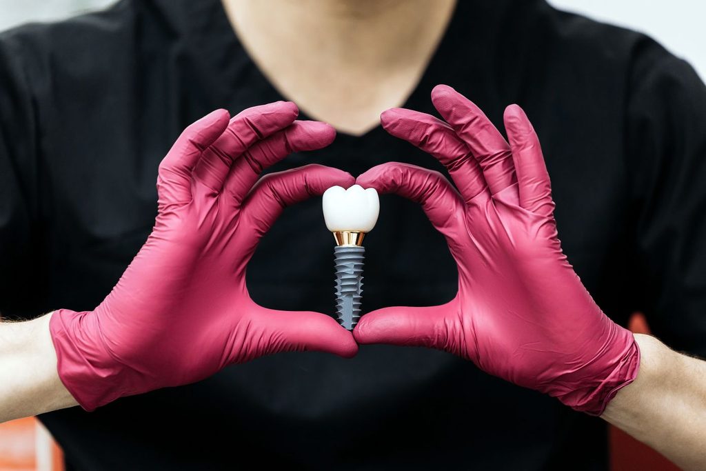 A dentist making a heart with his hands